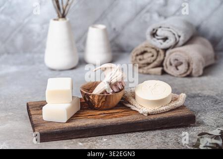 Various soaps and bathing accessories on wood and gray background Stock Photo