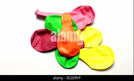 Colorful Deflated Latex Party Balloons Stacked On White Background Stock Photo
