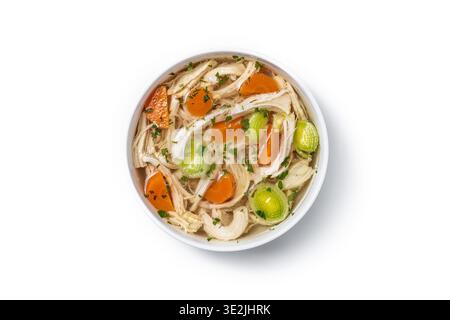 Homemade chicken soup in white bowl with carrots and celery isolated on white background Stock Photo