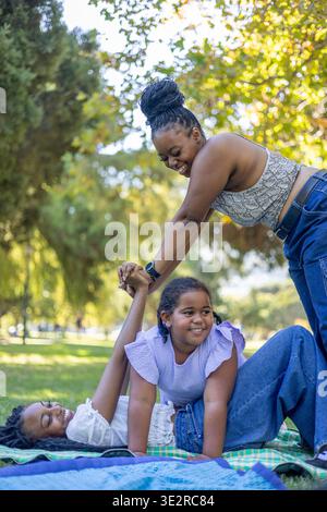 Black siblings interacting outside in a park Stock Photo