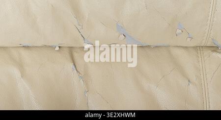 Beige couch upholstery with peeling surface showing wear, damage, and aging Stock Photo