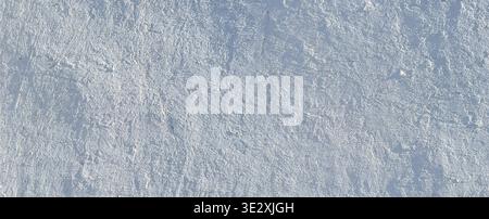 Rough white and gray stucco wall texture creating a distressed surface pattern Stock Photo