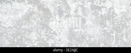 Distressed concrete wall texture with peeling faded white paint creating a rough background Stock Photo