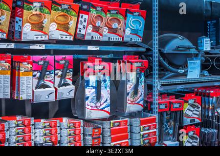 Close up view of barbecue accessories tools and grill equipment displayed on shelves in store. Sweden. Stock Photo