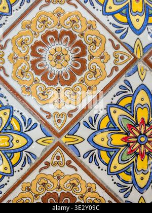 close up view of decorative Talavera tiles featuring detailed floral motifs and geometric elements in a repeating pattern Stock Photo