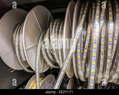 close up view of multiple spools holding coiled flexible LED light strips, ready for installation or purchase Stock Photo