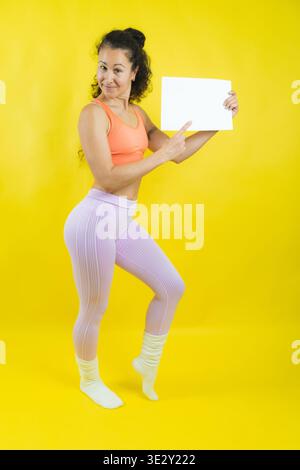 Woman holding empty white sign presenting healthy lifestyle Stock Photo