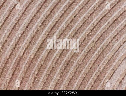 Soft beige lines curve gently across textured surface. Subtle gradients evoke calm, timeless elegance. Ideal for backgrounds, design, or mood-setting Stock Photo