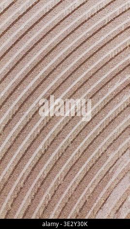Soft beige lines curve gently across textured surface. Subtle gradients evoke calm, timeless elegance. Ideal for backgrounds, design, or mood-setting Stock Photo