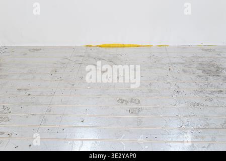 Underfloor heating system pipes are installing on polystyrene insulation panels with aluminum foil Stock Photo