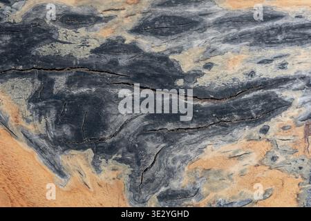 Abstract weathered wood texture with cracks and dark stains background Stock Photo