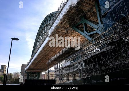 Construction and restoration work is taking place on the Tyne Bridge located in Newcastle Quayside. The project is aimed at preparing the bridge for its upcoming 100th anniversary in 2026. Scaffolding surrounds the structure as workers engage in vital maintenance and repairs. This view captures an important moment in the bridge's history, showcasing the efforts to preserve an iconic landmark in the city. Stock Photo