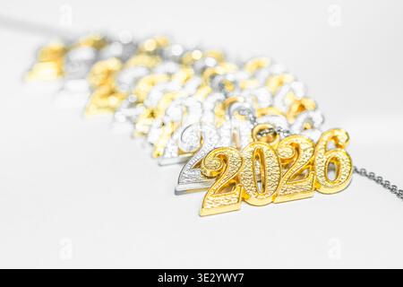 Several necklace pendants made of gold and silver with glittering zirconia, strung on a silver chain, numbers 2026 for the New Year's Eve celebration, Stock Photo