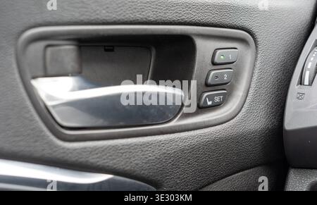 Close up of car interior door panel with seat memory buttons, modern vehicle technology and comfort control features Stock Photo