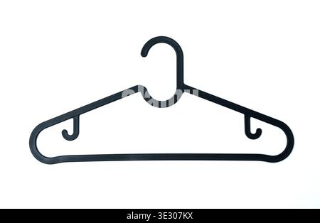 A black plastic clothes hanger with a smooth triangular frame and additional side hooks, isolated on a white background, showcasing a practical househ Stock Photo