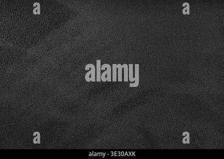 Decorative black velours fabric backdrop, wallpaper. Suede texture background. Car ceiling upholstery and covering. Surface of leatherette for texture Stock Photo