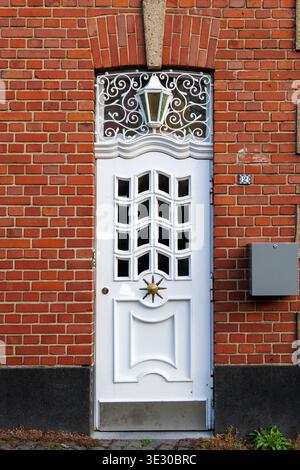 White Decorative Door in Red Brick Wall Stock Photo