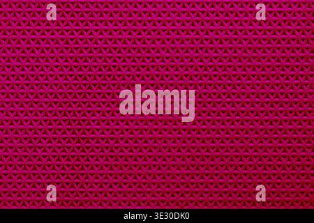 Abstract red surface with repeating triangular pattern, creating a modern, textured geometric background ideal for design projects. Stock Photo