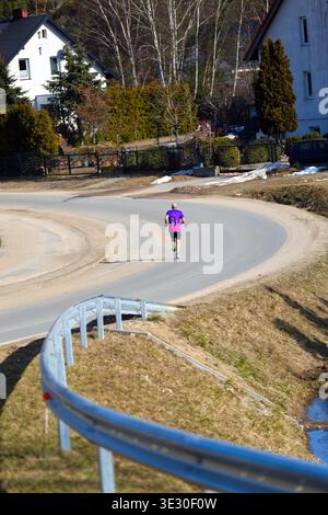man Running on a Winding Road in a Rural Landscape outdoors Stock Photo