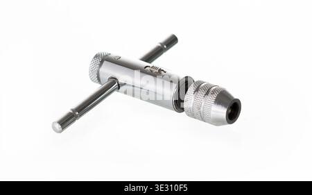 T-handle ratchet tap wrench for thread cutting isolated on white background. Chrome metal industrial tool. Stock Photo