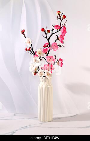Elegant sunny colorful banner with pink blooming sakura branches in vase, abstract spring flower arrangement and template for your creative work, disp Stock Photo