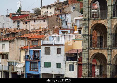 Traditional multi-colored houses and the arched stone facade of Palacio del Marques de Casa Torre in Igea, La Rioja, Spain. Stock Photo