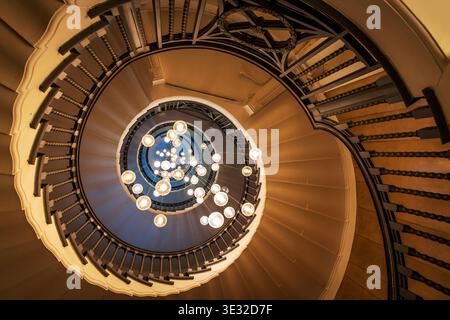 Cecil Brewer spiral staircase featuring Bocci lights , located in Heal's department store, Tottenham Court Road, London, England Stock Photo