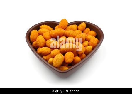 Crunchy Coated Peanuts in a Heart Shaped Bowl Isolated on White Background Stock Photo