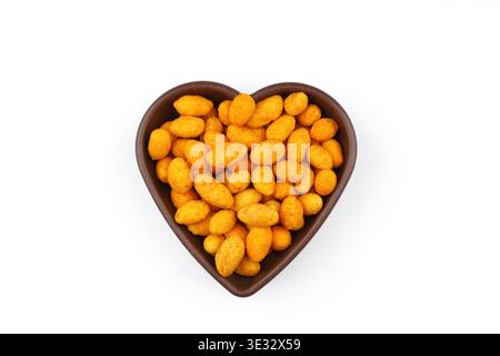 Crunchy Coated Peanuts in a Heart Shaped Bowl Isolated on White Background Stock Photo