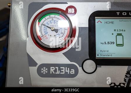 Automatic machine displaying r134a refrigerant level for car air conditioning service Stock Photo