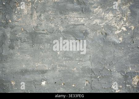 Dark grey concrete wall texture with heavily peeling paint chips and rustic scratches Stock Photo