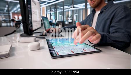 Young Financial Analyst Analyzes Expense Reports On Tablet For Business Expense Management Stock Photo