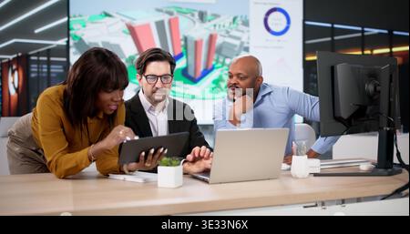Diverse Design Team Using GIS Software Maps Urban Land For Construction. Young Engineers Work On 3D Models Stock Photo