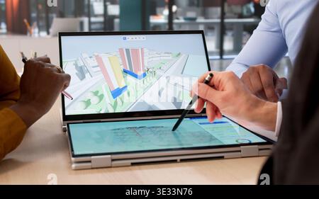 Person Uses Digital BIM Software On Laptop, Designing Real Estate Projects. Engineer Maps Urban Land With Tablet Stock Photo