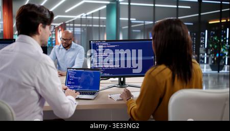 Diverse Team Of Software Developers Coding And Meeting In Modern Office. Programmers And Engineers Collaborating Stock Photo