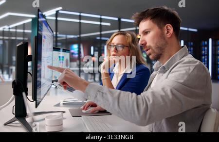 Business Professionals Analyzing KPI Dashboards On Laptops For Strategic Growth Stock Photo