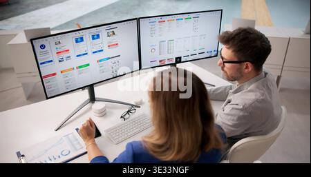 Creative Team Collaborating On App UI Design At Office Desk Stock Photo
