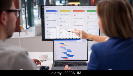Project Coordinator Diligently Revises Event Timeline With Scrum Tool On Laptop In Office Setting Stock Photo