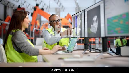 Young African Designer Uses Computer Software To Develop 3D Car Parts. Two Engineers Draft Stock Photo