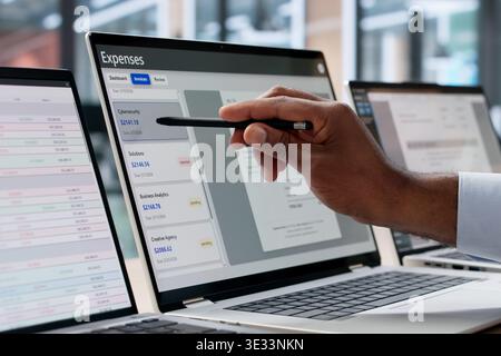Young African Finance Manager Uses Software For Expense Tracking And Reporting. Two Business Analysts Collaborate Stock Photo