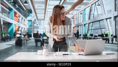 Office Worker Secretly Takes Confidential Business Papers During Work Time Stock Photo