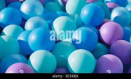 Plastic ball pit creating a vibrant background for children's play and fun Stock Photo