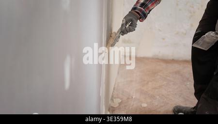 construction worker plastering gypsum walls renovation old home. copy space Stock Photo