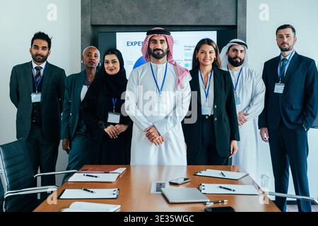 Diverse international business professionals standing confidently in a modern dubai boardroom. Symbolizing multicultural collaboration. Leadership and Stock Photo