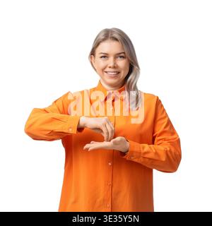 Young businesswoman with hearing aid using sign language on white background Stock Photo