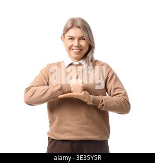 Young businesswoman with hearing aid using sign language on white background Stock Photo