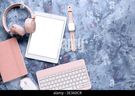 Composition with different modern gadgets and notebook on blue grunge background, closeup Stock Photo