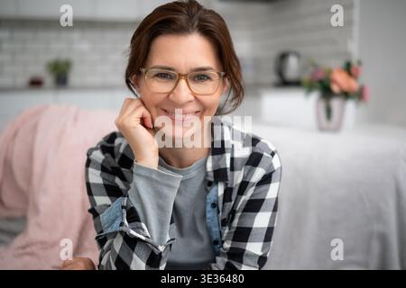Portrait Of A Happy Young Woman In Glasses At Home Stock Photo