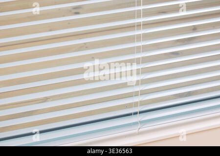Closeup of wooden blinds in a calm, natural setting with a gentle slant, showcasing texture and light filtering through the slats. Stock Photo