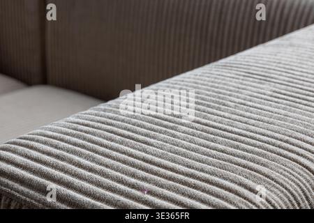 Empty space background. Close-up of textured fabric sofa with detailed stitching, showcasing soft material and precise craftsmanship. Stock Photo